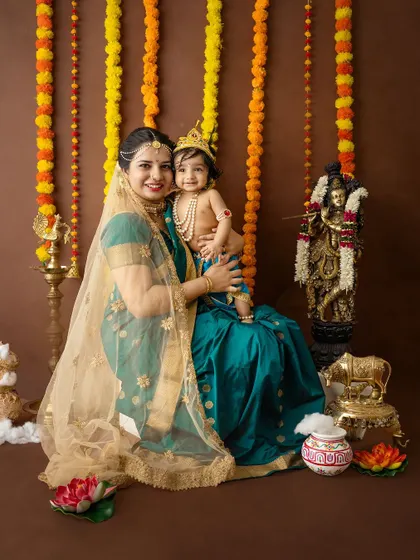 A smiling portrait of a mother and her baby, ready to celebrate the festival.