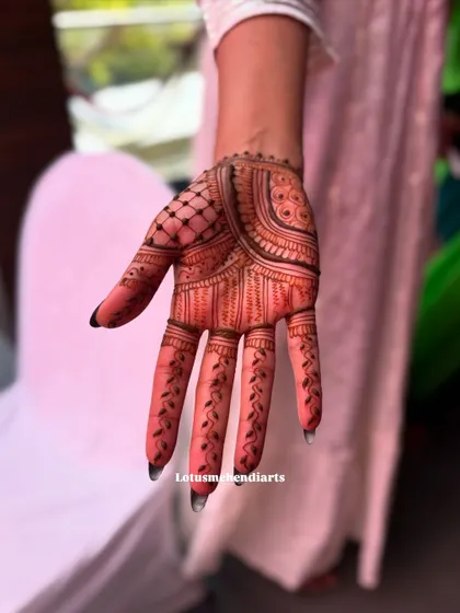 A single hand showcasing a detailed design with a mix of patterns. The dark red stain is just beginning to develop.
