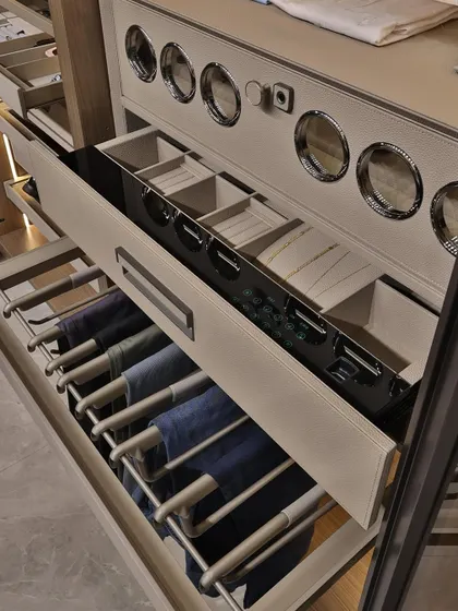This close-up shows the specialized storage solutions I incorporate, like pull-out trouser racks and sectioned drawers for watches and small accessories. It’s these details that define a luxury wardrobe.