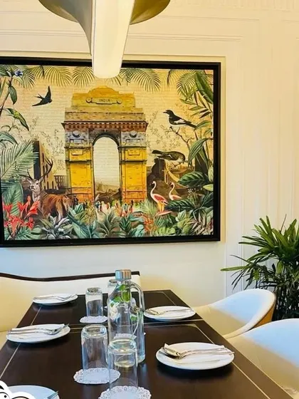 An artwork for Havemore restaurant, framing India Gate within a vibrant, tropical jungle. It's a whimsical take on a beloved Delhi landmark.