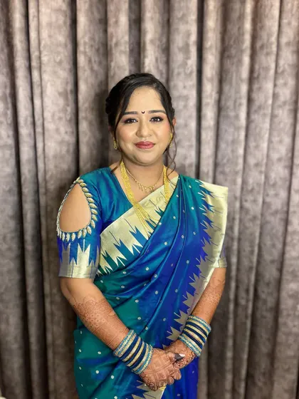 A full-length view of her engagement look, showing the elegant saree and the classic, timeless makeup.