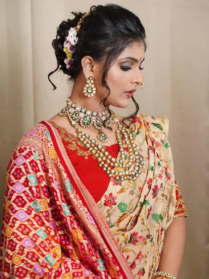 This side profile showcases the intricate texture and floral arrangement of the messy khopa. I use a combination of fresh flowers and a traditional hair pin to create a balanced and beautiful design.
