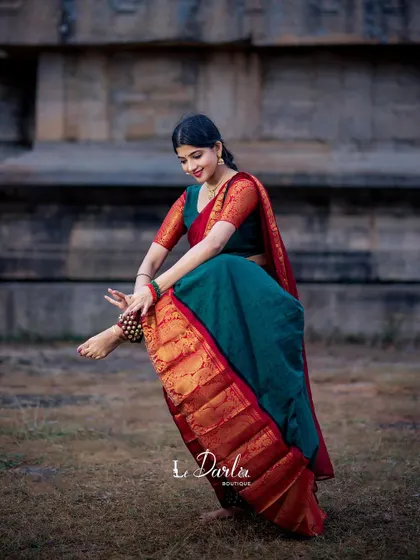 A moment of quiet grace during an outdoor shoot. The simple act of adjusting the salangai (ankle bells) is a ritual in itself, connecting the dancer to her art.