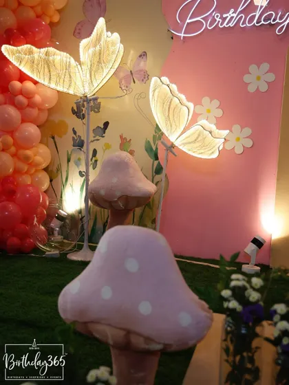 We use details like these illuminated butterfly lamps and oversized mushroom props to turn a party space into a magical fairy garden.