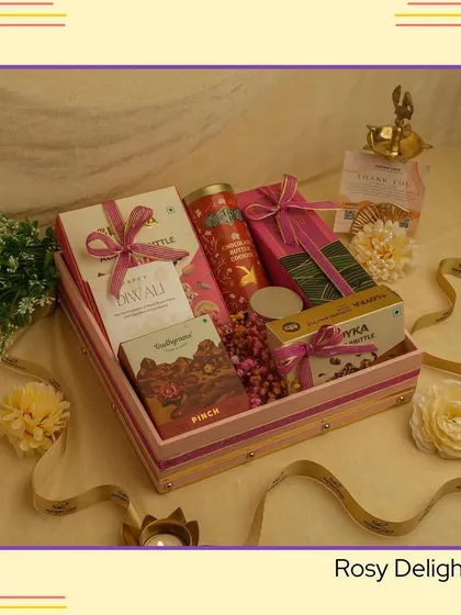 A closer look at the "Rosy Delight" hamper, showcasing the mix of textures and colors with its pink-striped box and assorted festive items.