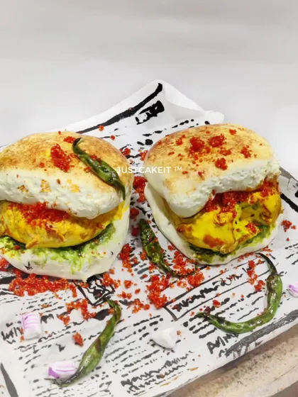 Is it a snack or is it cake? This hyper-realistic Vada Pav cake is my tribute to Mumbai's favourite street food. It's a butterscotch cake inside, designed to surprise and delight, and a perfect example of how I love to play with food themes.