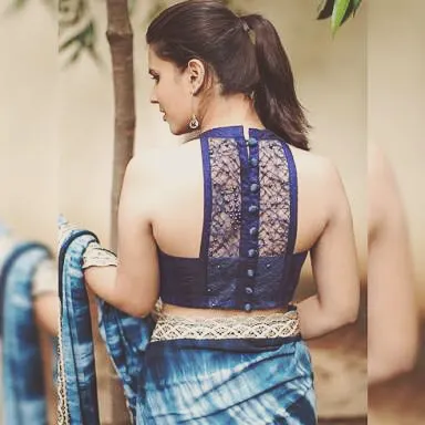 This high-neck, sleeveless blouse features a sheer lace panel on the back, offering a sophisticated and modern design. It's a perfect example of a custom Indo-Western blouse.