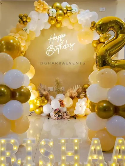 The complete setup for Trishaan's elegant 2nd birthday party, showing the balloon columns and full arch.