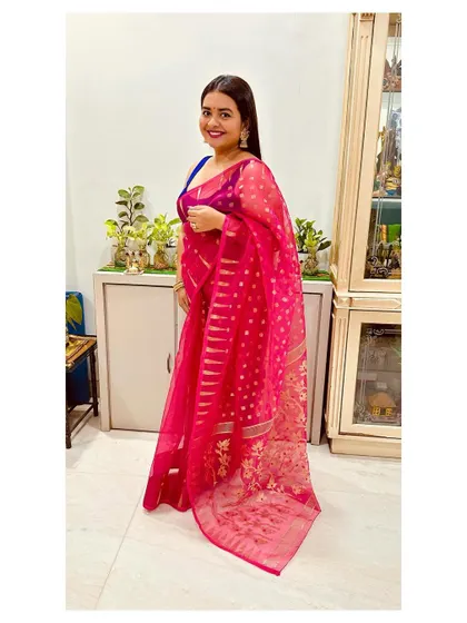 Celebrating Diwali in a beautiful rani pink Jamdani weave saree. The sheer texture and delicate gold motifs make it a light yet festive choice for any celebration.