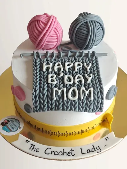 A cozy crochet-themed cake for "The Crochet Lady". This design features fondant yarn balls and a knitting pattern, perfect for a mom who loves to knit.