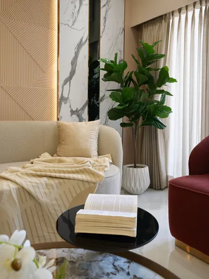 A close-up showing the soft textures of the sofa and throw blanket. Comfort is key in any living space I design.