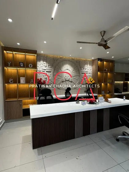 The completed office for Hari Mandir in Outram Lines, New Delhi, on its opening day. The design features a large, custom desk, back-lit shelving for display, and a serene, spiritual aesthetic suitable for the organization's purpose.