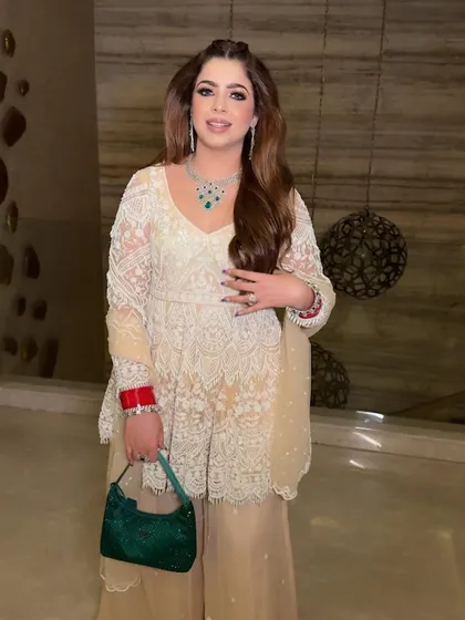 Posed and pretty. Her makeup is designed to look flawless and natural, enhancing her features without being overpowering.