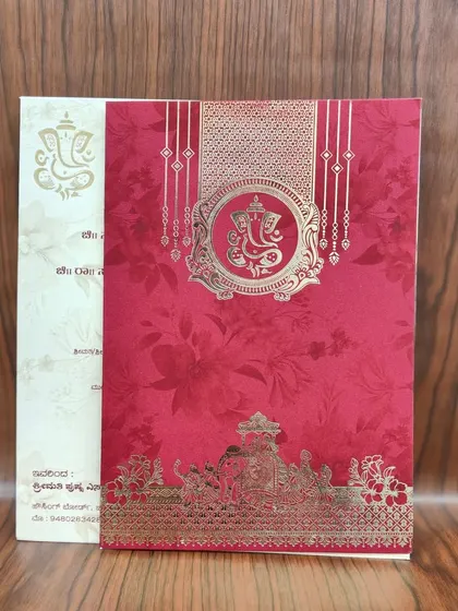 A classic red invitation with a gold Ganesha motif and an illustration of a traditional wedding ceremony.