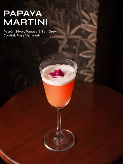 The Papaya Martini, a fruity and floral cocktail with papaya, Earl Grey, and rose vermouth.