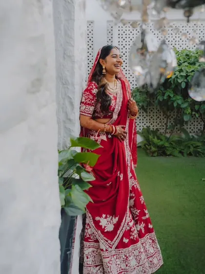 A candid shot of the bride's joyous laughter, capturing a moment of pure happiness.