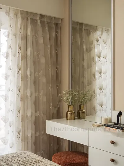 This shot highlights the sheer floral curtains that filter natural light, adding a gentle, airy ambiance to the vanity space. Decorative elements like golden vases enhance the serene and stylish atmosphere.