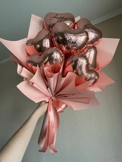 A full bouquet of personalized rose gold heart foil balloons. We can add a name or a short message to each balloon to make it extra special.