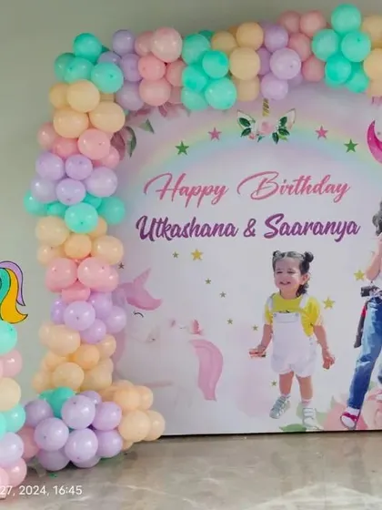 Another beautiful unicorn-themed backdrop, this one customized with photos of the birthday girls, Utkachana and Saaranya. Personal touches like this make the day extra special.