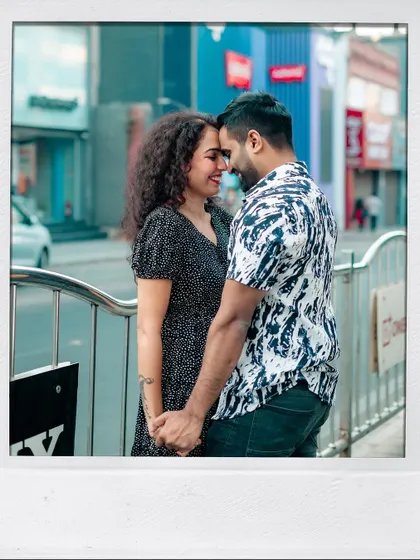 A romantic portrait of the couple, framed like a polaroid, taken during their urban shoot.