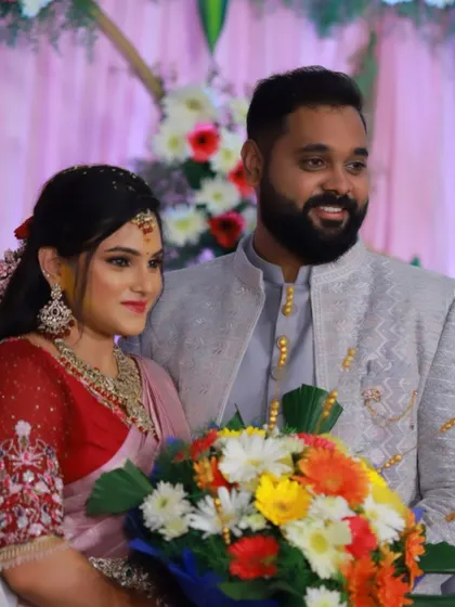 A beautiful couple at their engagement ceremony. The bride is wearing our custom pink saree and a heavily embroidered red blouse.