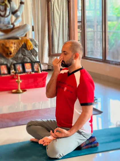 Practicing pranayama in a calm setting helps deepen the experience. This practitioner demonstrates the correct posture and hand mudra, essential for allowing prana, or life force energy, to flow freely.