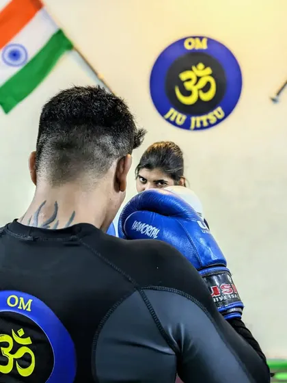 The confidence we create is visible in her eyes. This photo captures the intensity and focus of a student during a self-defense drill, ready to react and defend herself effectively.