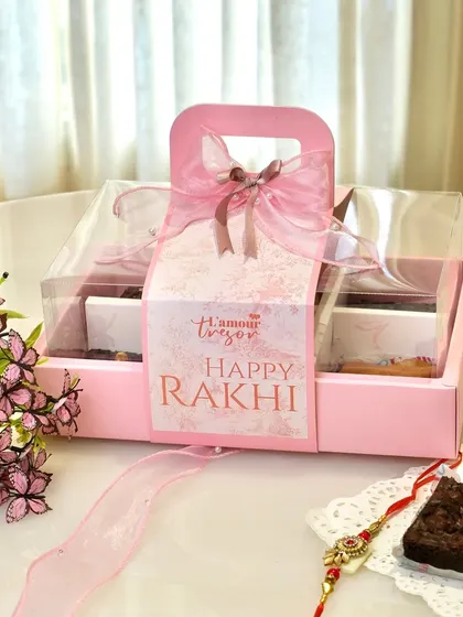 The complete package of our classic brownie and tea cake box, designed for Rakhi. The elegant pink packaging with a handle and ribbon makes it a timeless and heartfelt gift.