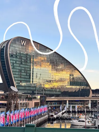 A simple white squiggle adds a touch of modern art to the photo of this cool architectural building in Sydney.
