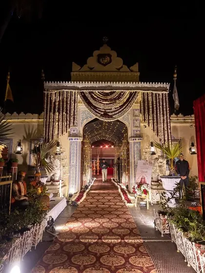 The grand entrance to a royal wedding at Jagmandir, adorned with traditional floral garlands and intricate decor, welcoming guests to the celebration.