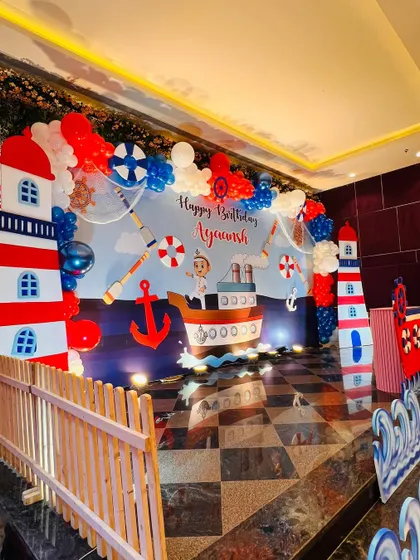 The main stage for the nautical birthday, designed to look like a pier with a boat, lighthouses, and waves.