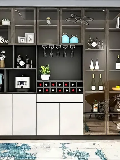 A large and modern bar cabinet designed for the serious entertainer. It includes ample glass storage, a built-in wine rack, and display shelves, all framed in a sleek black metal structure.