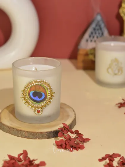 My 'Shri Krishna' candle, adorned with a peacock feather emblem. This candle is a beautiful tribute, perfect for creating a serene and spiritual atmosphere.