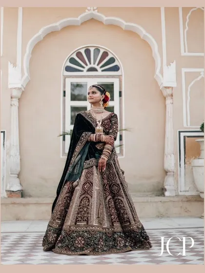 A full-length bridal portrait at Hotel Chomu Palace, capturing the grandeur of the venue and the bridal outfit.