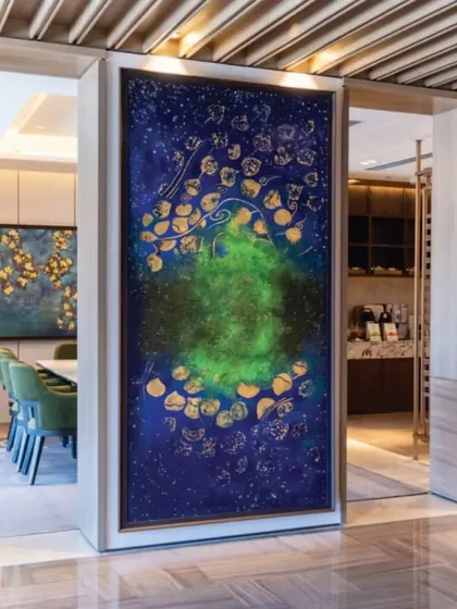 The 'Aurora Borealis' painting creating a focal point in a lounge at JW Marriott. The artwork's cosmic theme and vibrant colors are chosen to complement the hotel's modern and luxurious interior design.