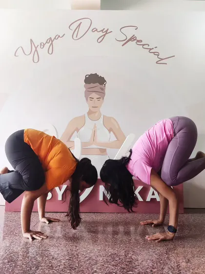 A fun moment from a Yoga Day special event, holding a crow pose with a fellow yogi. Arm balances are as much about mindset as they are about strength.