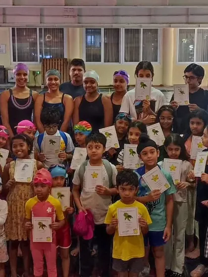 Another group of proud swimmers holding up their certificates. Our structured program ensures that everyone can see their progress and feel a sense of accomplishment.