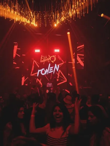 A partygoer loving the vibe right in front of the console at SinQ Nightclub. It's all about creating those individual moments of joy.