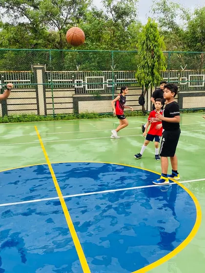 Passing drills continue on the wet court, honing precision.