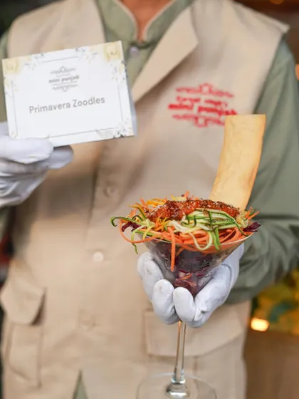 A server presents our Primavera Zoodles. This dish is a perfect example of our commitment to offering healthy, gourmet options that are both visually appealing and delicious.
