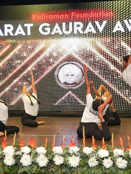 A creative and beautiful group formation combining backbends and balancing poses, designed to create a memorable visual for the audience.