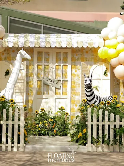 A sunny safari adventure comes to life with a custom-built gingham-patterned house and cheerful animal friends. We transformed this outdoor space with bright yellow hues, lush sunflowers, and playful details for a memorable first birthday celebration.
