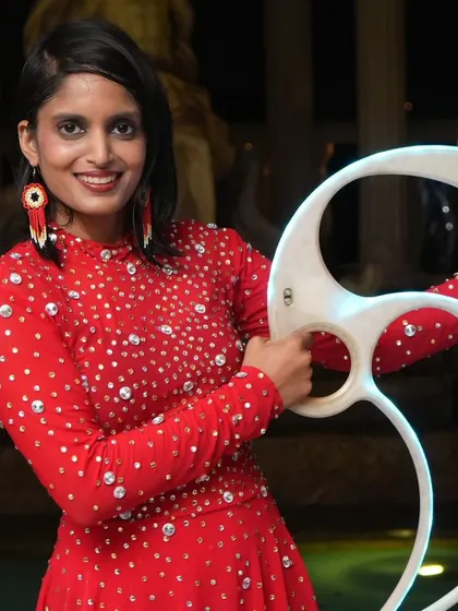 A close-up shot showing the detail of the sequined dress and the unique shape of the pixel fans. Every element of the show is carefully considered.