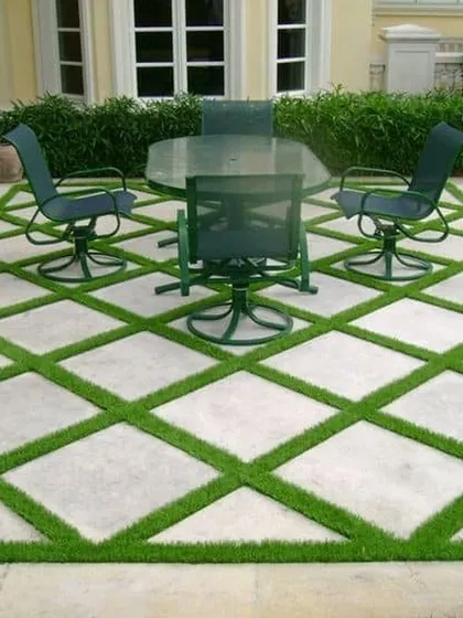 Your floor doesn't have to be boring. For this patio, I created a custom diamond pattern by integrating artificial grass with the existing stone tiles. This is a great example of how we can create a unique, high-end look for your outdoor space.