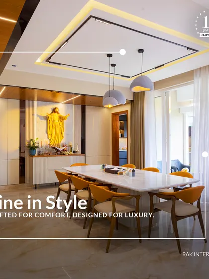 Dine in style with this luxurious setup. The design features a prayer niche seamlessly integrated into the dining area, combining functionality with spiritual elegance. The orange chairs add a vibrant pop of color.