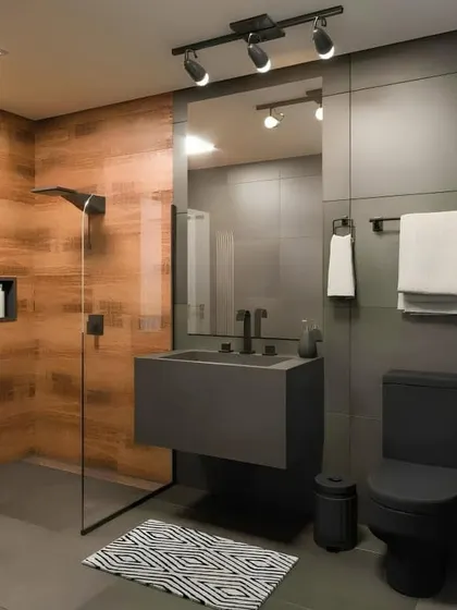 A minimalist bathroom with a dark, moody aesthetic. It features grey wall tiles, a floating grey sink, and black fixtures for a cohesive and ultra-modern look.
