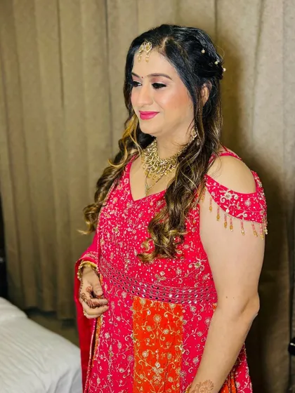 A client ready for a party in a bright pink and orange anarkali.