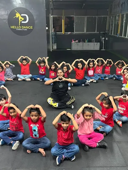 An instructor joins the students in the center of their heart formation, showing the close bond we share. We are proud to be a part of their dance journey.