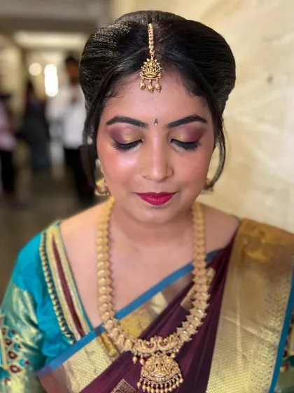 A close-up of the eye makeup for this wedding guest look. The blend of gold and burgundy on the lids adds a touch of drama that is perfect for a festive celebration.