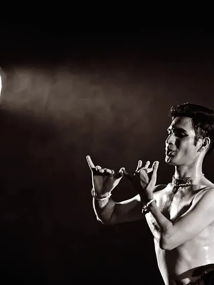 A black and white shot capturing the intensity of a performance, with the stage light creating a dramatic effect. I often use lighting to enhance the mood and focus of my storytelling.